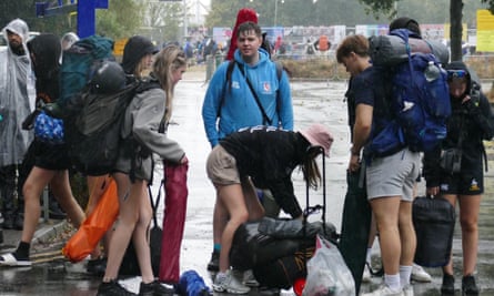 People on their way to the Reading festival on Thursday amid downpours.