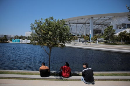 People sit outside of SoFi Stadium as Los Angeles prepares for the 2026 World Cup
