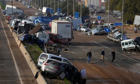 Vehicles are seen piled up after being swept away by floods on a motorway in Valencia, Spain,