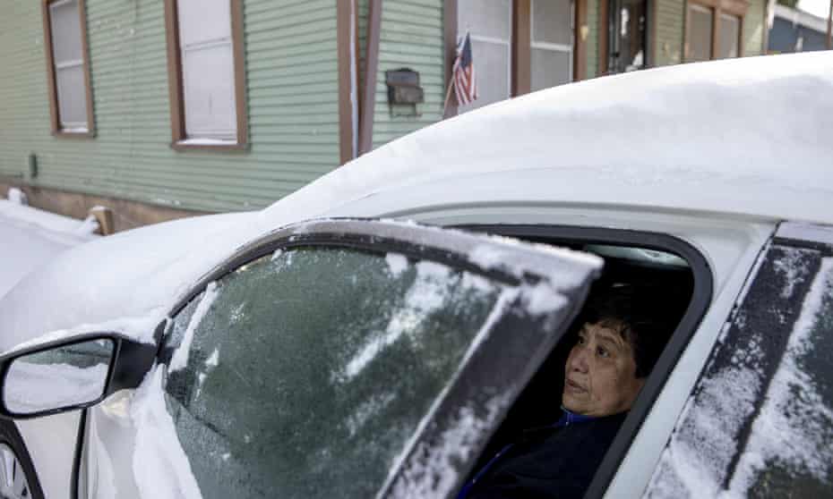 Maria Pineda uses her car to get warm in East Austin, Texas. Pineda said her home has been without power since Monday. 