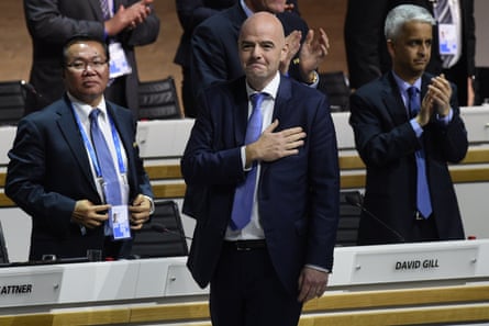 Infantino stands holding his hand to his heart