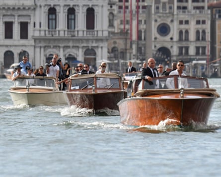 Boats carrying Bezos and guests travel past St Mark’s Square.