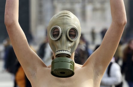 A model representing Peta wears a gas mask to demonstrate against the use of fur at Milan fashion week.