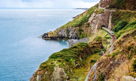 europe's greatest train journeys series View from the cliff walk between Bray and Greystones, with grassy cliffs and sea, in Co Wicklow, Ireland.