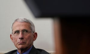 Dr Anthony Fauci, director of the National Institute of Allergy and Infectious Diseases, looks up toward the lectern as Donald Trump leads the daily coronavirus disease task force briefing.