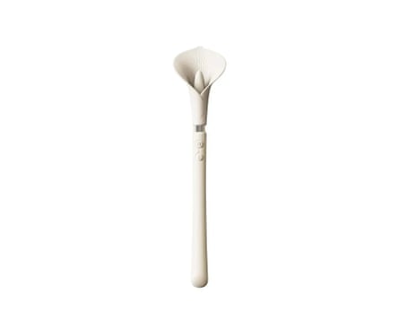 A Sh! Zalo Calla Lily Clitoral Wand Vibrator. It is lily shaped and in white.
