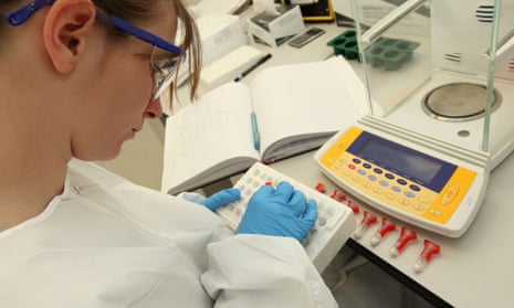 Woman in white coat in lab