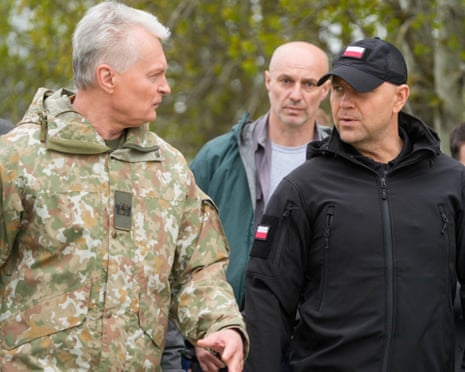 Lithuanian president Gitanas Nausėda walks next to Polish President Karol Nawrocki during the