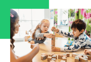 Children making a tower of wooden blocks