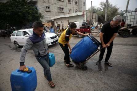 Palestinian civilians collect water using plastic jerrycans