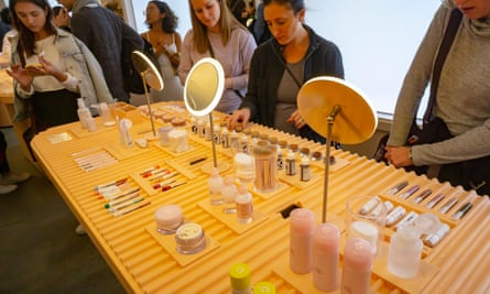 ‘We think about hospitality rather than traditional sales’: customers trying on makeup crowd a Glossier pop-up.