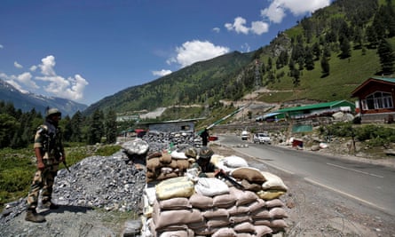 India’s border security force soldiers stand guard at a checkpoint along a highway leading to Ladakh, at Gagangeer in Kashmir’s Ganderbal district
