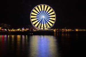 Seattle’s 175-foot Great Wheel lights up the waterfront in the colors of the Ukrainian flag. Built in 2012, the Great Wheel remains a popular tourist attraction.