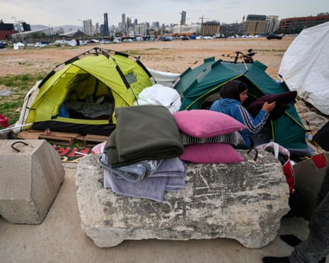 A displaced woman packs her family's belongings in Beirut as she prepares to return home after the Lebanon-Israel ceasefire began