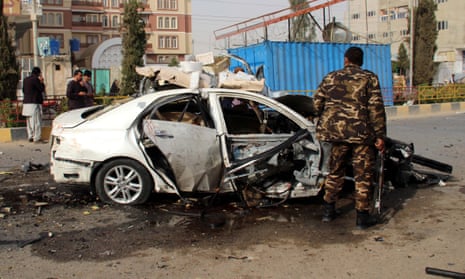 Afghan security officials inspect the scene of a blast in Lashkargah, Afghanistan, which killed the journalist Elyas Dayee in November 2020