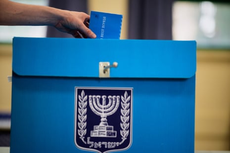 A voter casts his ballot at a school used as a polling station during Israel’s general election in Tel Aviv.