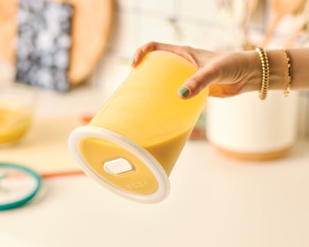 A person holding an AnyDay LeakProof 4cup upside down