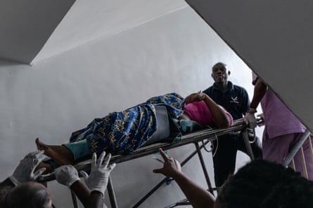 A woman being brought up to the surgery room on a stretcher.
