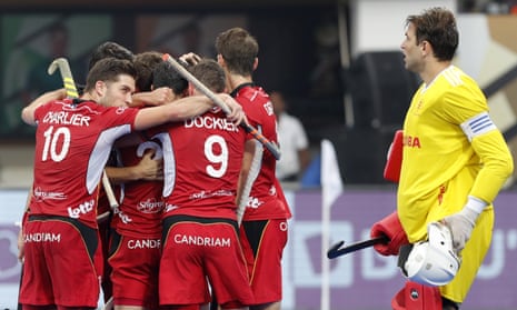 Belgium players celebrate as England’s George Pinner watches on.