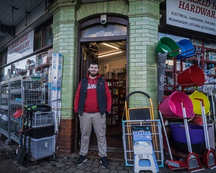 Tom Jarman posing outside Sacred Heart hardware store