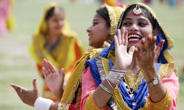 Indian students wearing traditional Punjabi attire perform Giddha folk dance from Punjab as they take part in the full and final dress rehearsal for India’s independence day parade and celebrations in Amritsar, India