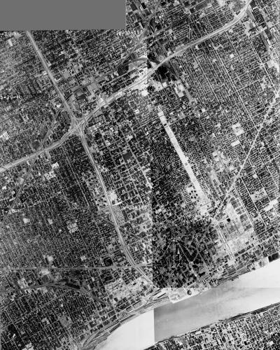 An aerial photomosaic of Detroit, 1961. By this point, the construction of I-94 and Route 10 were complete, with I-75 taking shape. The community of Black Bottom was gutted in the process.