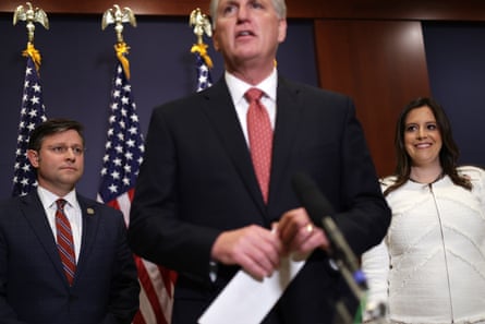The House minority leader, Kevin McCarthy, speaks to members of the press as Stefanik looks on after she was elected to replace Liz Cheney as the No 3 House Republican in May 2021.