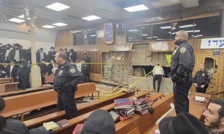 Police stand at the entrance of the tunnel in the Chabad synagogue in Brooklyn.