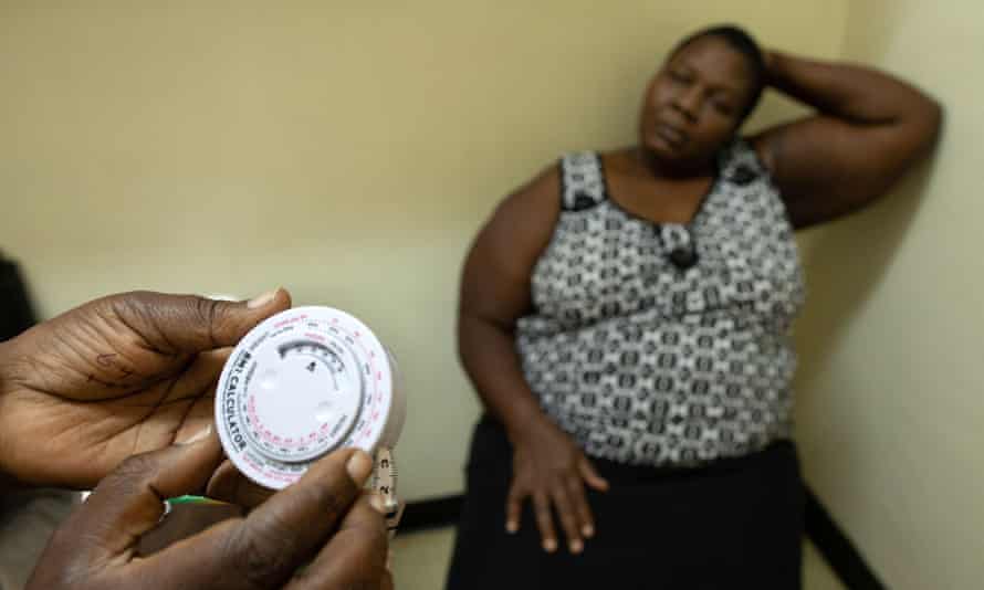 Magdalene Wanjiru, a 46-year-old Kenyan woman, has her BMI calculated by a nutritionist during a checkup at the Kenyatta National Hospital in Nairobi