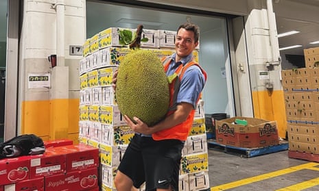 Man holds jackfruit half his size