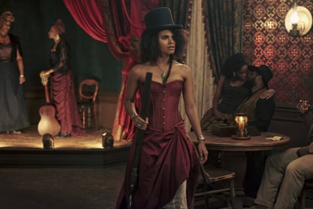 Zazie Beetz, in a corseted dress, as Stagecoach Mary