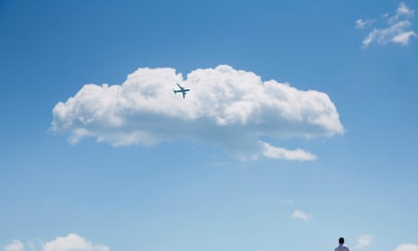 Solo figure observing a jet plane in flight
