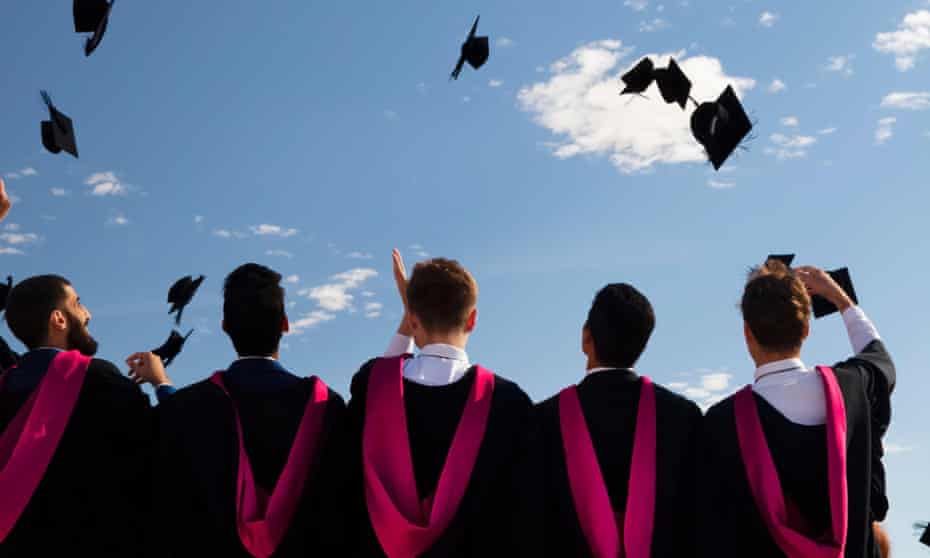 University graduates toss  caps into the air at graduation ceremony, Warwick