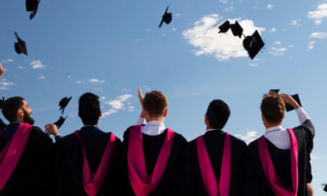 University graduates toss  caps into the air at graduation ceremony, Warwick