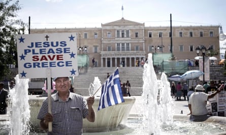 A Greek man stands in front of the parliament building in Athens
