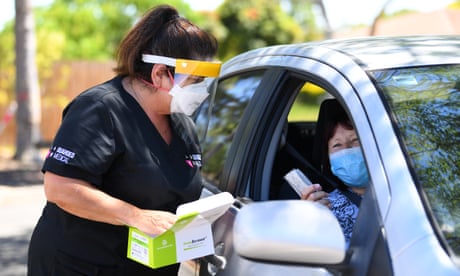 Woman offering RAT tests to driver in car