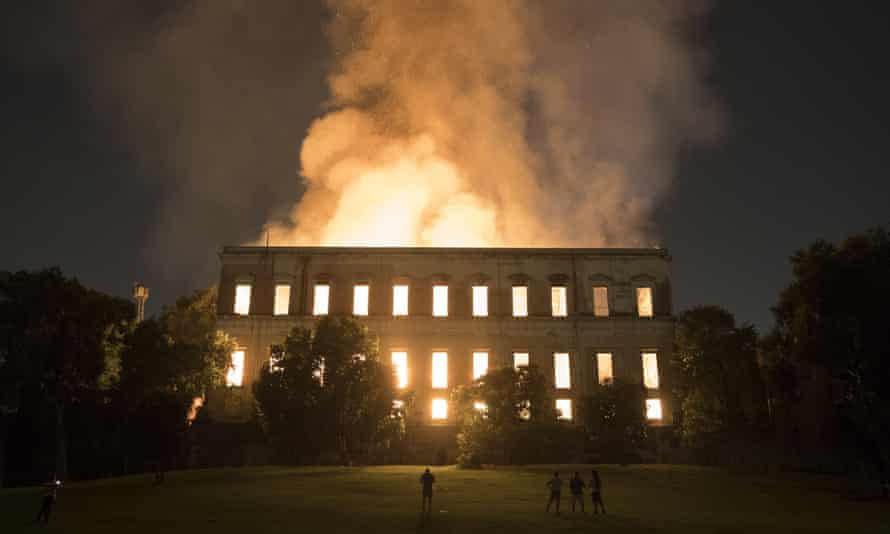 People watch as flames engulf the 200-year-old National Museum of Brazil in Rio de Janeiro on 2 September 2018.