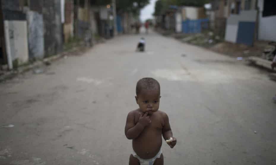 A baby in one of the poorest areas of the City of God favela in Rio de Janeiro. Nationally, the death rate for children up to the age of five also rose by nearly 4% in 2016.