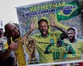 A fan poses with a poster that reads: ‘Go Neymar, our hope for a sixth World Cup title’