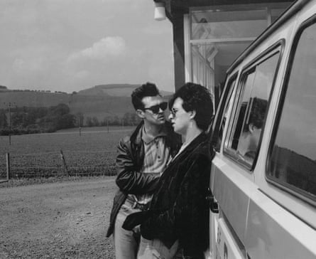 Morrissey and Johnny Marr of the Smiths standing by the side of a van in 1984
