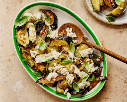 A plate of courgettes, feta and preserved lemon, with a wooden spoon