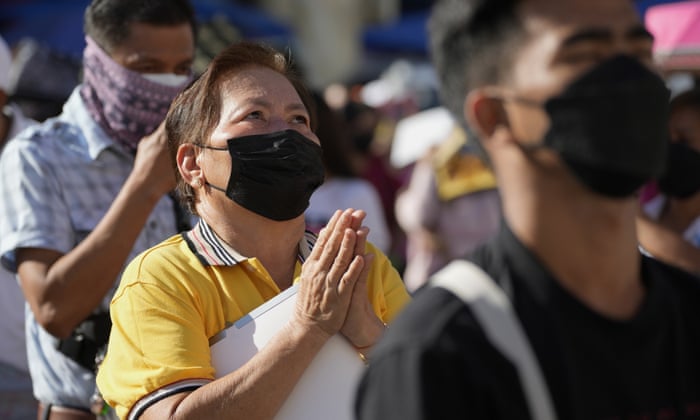 Devotees, wearing face masks to prevent the spread of the coronavirus, pray during a mass at the Quiapo church in Manila, Philippines.