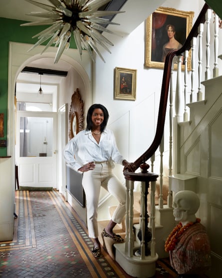 Lady of the house: Ambrice Miller in the elegant hallway beneath a starburst chandelier.