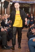 Gosha Rubchinskiy wears the infamous DHL t-shirt on the Vetements runway during Paris fashion week in October 2015.