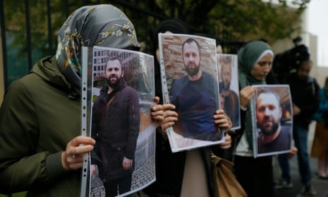 People hold portraits of Zelimkhan Khangoshvili, a former Chechen fighter who was murdered by Vadim Krasikov, in front of the German embassy in Tbilisi, Georgia.