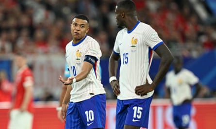 Kylian Mbappe speaks with Marcus Thuram during the match between Austria and France on 17 June.