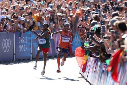 Tigst Assefa of Ethiopia and Sifan Hassan of the Netherlands collide during the Women’s Marathon at the Paris Olympic Games