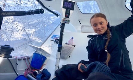 A girl with a long braid smiling onboard a boat
