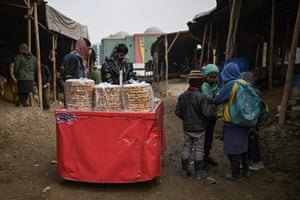 A vendor sells sweets at a cattle market