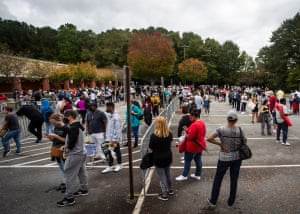Hundreds of people wait in line for early voting on Monday, in Marietta, Georgia.